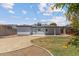 Spacious backyard featuring a gravel area, grass, and a covered patio, perfect for outdoor entertaining at 1367 E Mitchell Dr, Phoenix, AZ 85014