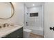 Contemporary bathroom with modern vanity, round mirror, tub and shower combination at 1367 E Mitchell Dr, Phoenix, AZ 85014