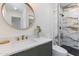 Updated bathroom featuring a modern vanity, round mirror, and beautifully tiled shower at 1367 E Mitchell Dr, Phoenix, AZ 85014