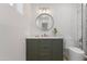 Stylish bathroom with an elegant vanity, round mirror, and modern toilet at 1367 E Mitchell Dr, Phoenix, AZ 85014