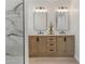 Modern bathroom vanity with double sinks, contemporary lighting and a wood cabinet at 1367 E Mitchell Dr, Phoenix, AZ 85014
