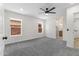 Bright bedroom featuring neutral carpet, large windows, and a modern ceiling fan at 1367 E Mitchell Dr, Phoenix, AZ 85014