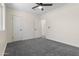 Bright bedroom boasts neutral tones, ceiling fan, two closets, and neutral gray carpet at 1367 E Mitchell Dr, Phoenix, AZ 85014