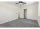 Bright bedroom with gray carpet, a large window, and a closet with double doors at 1367 E Mitchell Dr, Phoenix, AZ 85014