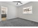Well-lit bedroom featuring a large window and gray carpet, with a bathroom view at 1367 E Mitchell Dr, Phoenix, AZ 85014