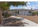 Charming single-story home with a curving walkway, desert landscaping, and modern architectural design at 1367 E Mitchell Dr, Phoenix, AZ 85014