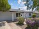 Single-story house showcasing desert landscaping, complemented by white trim and a well-maintained lawn at 1367 E Mitchell Dr, Phoenix, AZ 85014