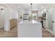 Bright kitchen with white cabinets, a quartz island, stainless steel appliances, and a modern pendant light at 1367 E Mitchell Dr, Phoenix, AZ 85014