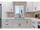 Close up of the kitchen sink and window, showcasing bright countertops and modern fixtures at 1367 E Mitchell Dr, Phoenix, AZ 85014