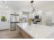 Well-lit kitchen featuring an island with quartz countertop, stainless steel appliances, and modern lighting fixtures at 1367 E Mitchell Dr, Phoenix, AZ 85014