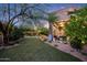Expansive backyard with a covered patio, lush lawn, and inviting outdoor seating area at 14598 E Corrine Dr, Scottsdale, AZ 85259