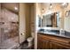 Elegant bathroom with a walk-in shower, pendant lighting, and a vanity with granite countertop at 14598 E Corrine Dr, Scottsdale, AZ 85259