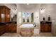 Luxurious bathroom with tub and dual vanities and travertine tile at 14598 E Corrine Dr, Scottsdale, AZ 85259