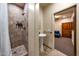 Modern bathroom featuring a tile shower, a pedestal sink, and an open doorway to another room at 14598 E Corrine Dr, Scottsdale, AZ 85259