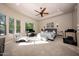 Spacious bedroom with trey ceiling, ceiling fan, and a comfortable sitting area at 14598 E Corrine Dr, Scottsdale, AZ 85259