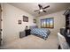 This bedroom features neutral colored walls, shutters, and a ceiling fan with a light fixture at 14598 E Corrine Dr, Scottsdale, AZ 85259