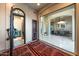 Open foyer with tile flooring, arched doorway, and views into other rooms, creating a seamless flow throughout the home at 14598 E Corrine Dr, Scottsdale, AZ 85259
