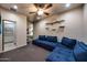 Cozy living room boasts a large blue sectional, ceiling fan and a decorative wall display at 14598 E Corrine Dr, Scottsdale, AZ 85259