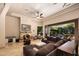 Spacious living room with a fireplace, comfortable seating, and sliding doors leading to the outdoor living area at 14598 E Corrine Dr, Scottsdale, AZ 85259