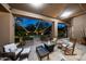 Outdoor patio featuring a fire pit, cozy seating, and string lights with a view of the pool at 14598 E Corrine Dr, Scottsdale, AZ 85259