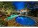 Inviting pool and spa with lush landscaping and ambient lighting for evening enjoyment at 14598 E Corrine Dr, Scottsdale, AZ 85259