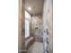 Walk-in shower showcasing travertine tile, bench seating, and sleek fixtures at 14598 E Corrine Dr, Scottsdale, AZ 85259