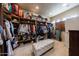 Large walk-in closet with custom shelving and seating at 14598 E Corrine Dr, Scottsdale, AZ 85259