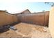 This backyard is surrounded by brick walls and features dirt for new growth at 16251 N 91St Dr, Peoria, AZ 85382