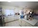 Open concept kitchen with island, tile floors, and stainless steel fridge at 16251 N 91St Dr, Peoria, AZ 85382