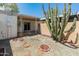 Desert backyard featuring cacti, trees, a patio, and decorative gravel at 1808 W Rose Ln, Phoenix, AZ 85015