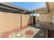 Desert backyard featuring cacti, trees, covered patio, decorative gravel, and privacy walls at 1808 W Rose Ln, Phoenix, AZ 85015