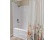 Well-lit bathroom featuring a shower-tub combo with floral curtain at 1808 W Rose Ln, Phoenix, AZ 85015
