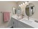 Modern bathroom featuring double sinks, white cabinets, and quartz countertops at 1808 W Rose Ln, Phoenix, AZ 85015