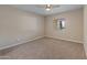 Neutral bedroom featuring tan walls, carpet, ceiling fan, and a window at 1808 W Rose Ln, Phoenix, AZ 85015