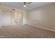 Comfortable bedroom with neutral carpet, ceiling fan, and ensuite bathroom access at 1808 W Rose Ln, Phoenix, AZ 85015