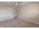 Neutral bedroom featuring tan walls, carpet, ceiling fan, and closet at 1808 W Rose Ln, Phoenix, AZ 85015