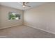 Sunlit bedroom with carpet floors and a window view at 1808 W Rose Ln, Phoenix, AZ 85015