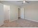 Bright bedroom with carpet floors, a ceiling fan, and closet space at 1808 W Rose Ln, Phoenix, AZ 85015