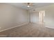 Cozy bedroom with neutral carpet, ceiling fan, and ample closet space at 1808 W Rose Ln, Phoenix, AZ 85015