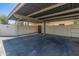 Covered carport featuring a gray roof and concrete floor at 1808 W Rose Ln, Phoenix, AZ 85015