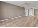 Spacious living room featuring wood floors, ceiling fan, and neutral paint at 1808 W Rose Ln, Phoenix, AZ 85015