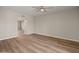 Open living room with wood-look floors, ceiling fan, and neutral paint, creating a comfortable space at 1808 W Rose Ln, Phoenix, AZ 85015