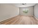 Inviting living room with wood-look floors, neutral walls, and a large window for natural light at 1808 W Rose Ln, Phoenix, AZ 85015