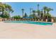 Community pool featuring trees, chairs, umbrellas, and lounge chairs at 1808 W Rose Ln, Phoenix, AZ 85015