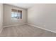 Bright bedroom with carpet flooring, window and neutral paint color at 18351 W Patrick Ln, Surprise, AZ 85387