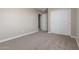 Bedroom featuring neutral paint and carpet flooring, closet, and a doorway at 18351 W Patrick Ln, Surprise, AZ 85387