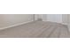 Bedroom with neutral walls and carpet flooring, featuring a closet and door at 18351 W Patrick Ln, Surprise, AZ 85387