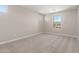 Bright bedroom with carpet floors, neutral paint, and large windows for lots of light at 18351 W Patrick Ln, Surprise, AZ 85387