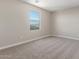Bedroom with a neutral color palette, large window providing natural light, and comfortable carpeting at 18351 W Patrick Ln, Surprise, AZ 85387
