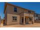 Rear exterior view of the stucco home with a covered patio and well-placed windows at 18351 W Patrick Ln, Surprise, AZ 85387